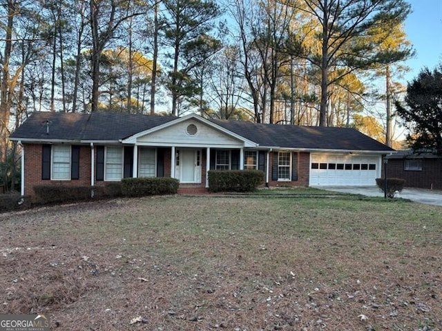 ranch-style house with driveway, brick siding, a front lawn, and an attached garage