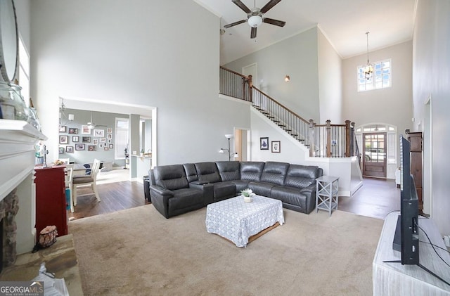 living room with a wealth of natural light, hardwood / wood-style flooring, and ornamental molding