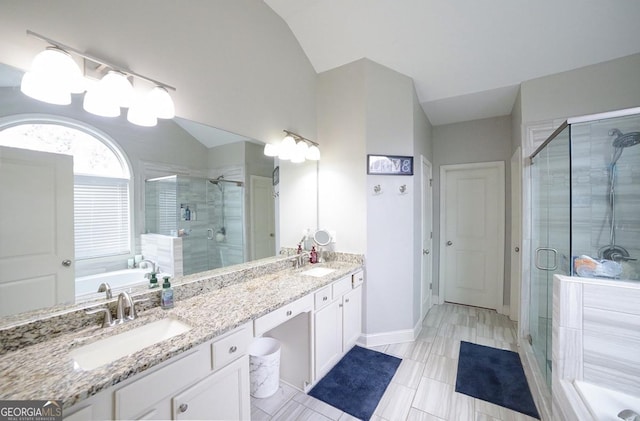 bathroom with vaulted ceiling, walk in shower, and vanity