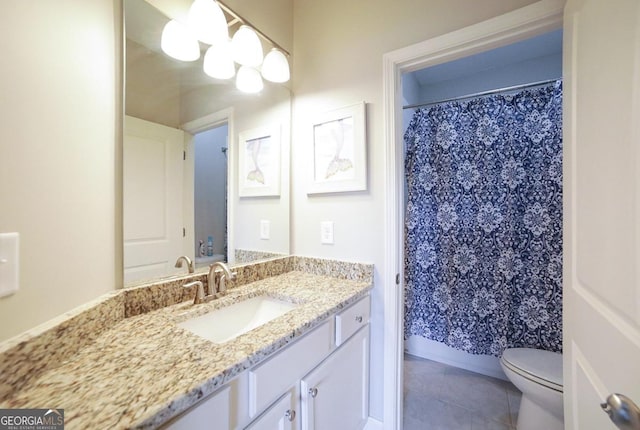 bathroom with toilet, tile patterned flooring, curtained shower, and vanity