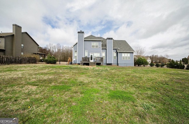 back of house featuring a yard and a deck