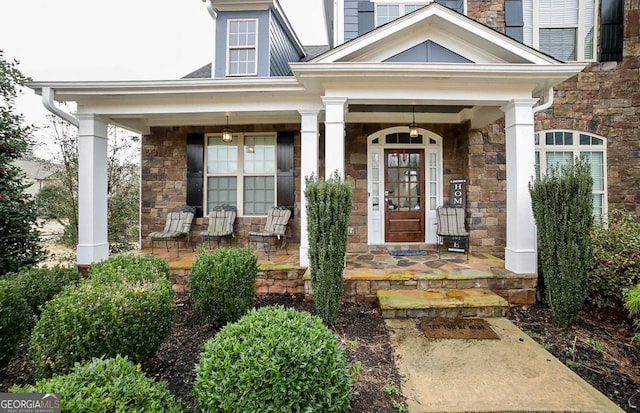 view of exterior entry with a porch