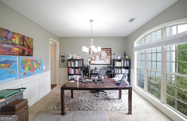 office area with light carpet and an inviting chandelier