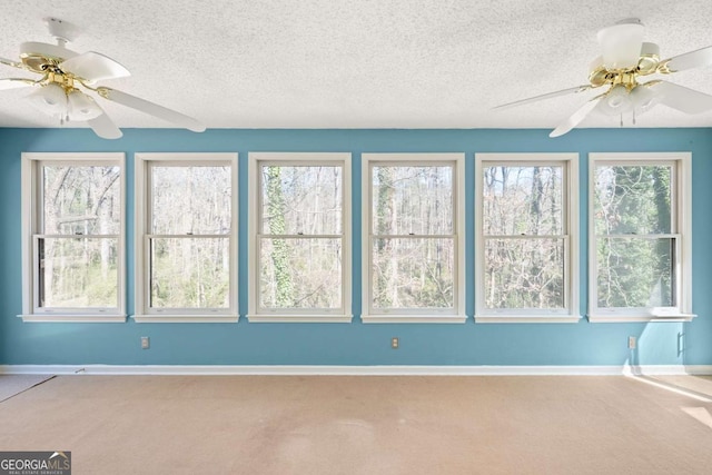 interior space with a textured ceiling and ceiling fan