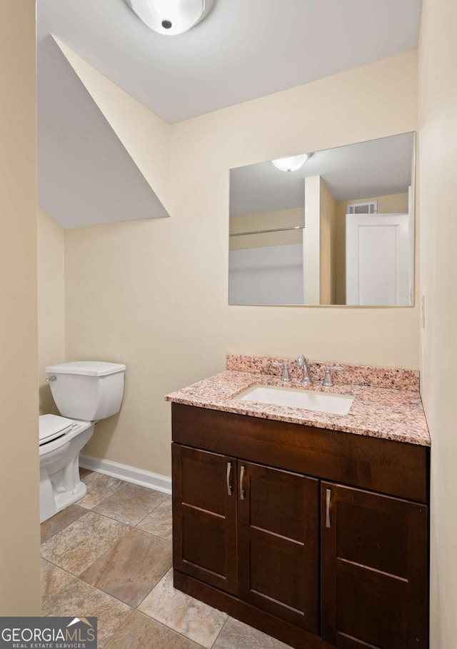 bathroom with toilet and vanity