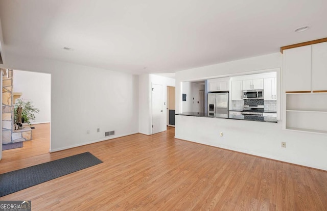 unfurnished living room featuring light hardwood / wood-style floors