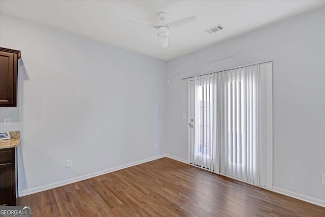 unfurnished room with ceiling fan and hardwood / wood-style floors