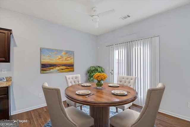 dining area featuring dark hardwood / wood-style floors and ceiling fan