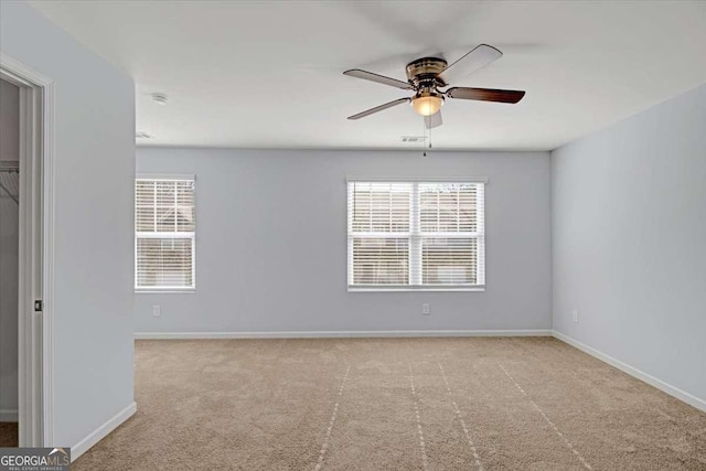 spare room with light carpet and ceiling fan