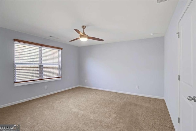 carpeted spare room featuring ceiling fan