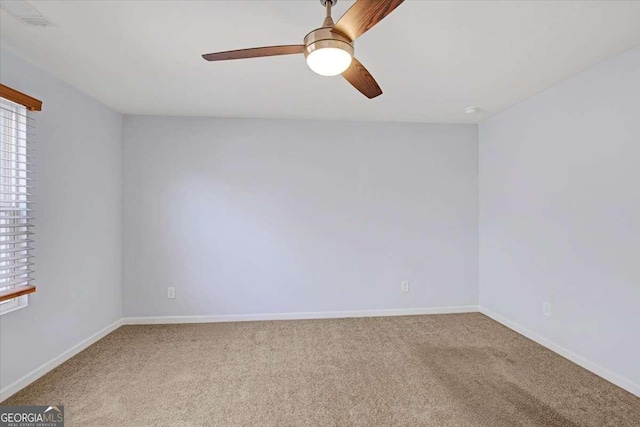 carpeted empty room with plenty of natural light and ceiling fan