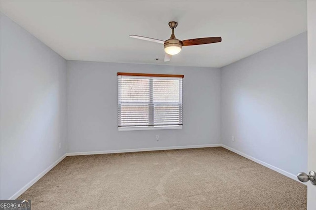 carpeted spare room featuring ceiling fan