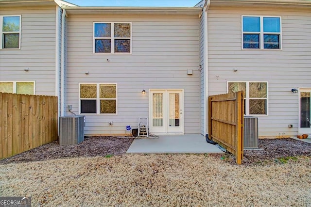 back of property with a patio and central AC