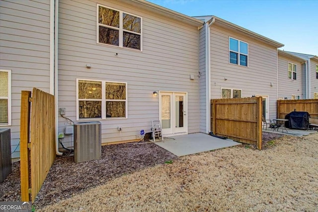 rear view of house with cooling unit and a patio area