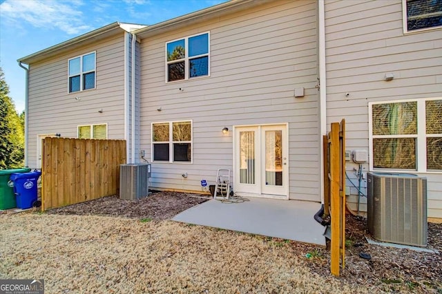 rear view of house with a patio and central AC unit