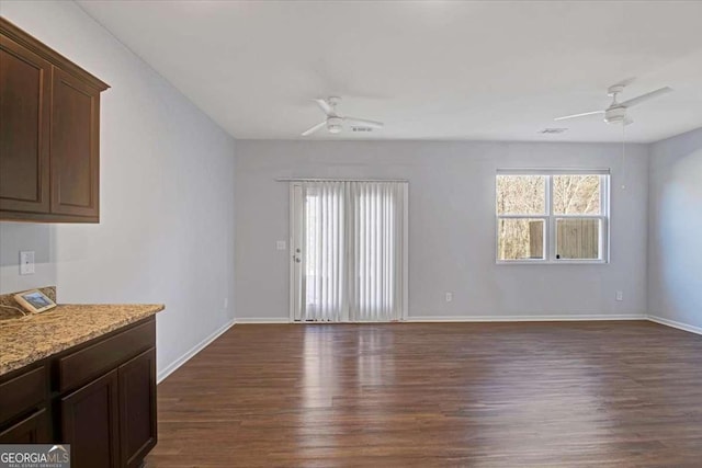 interior space featuring dark hardwood / wood-style flooring and ceiling fan