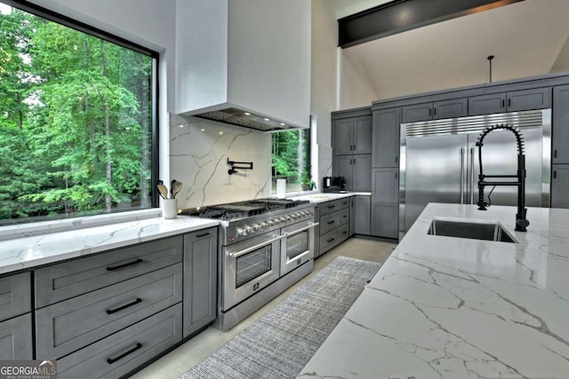 415 Green Ridge Trl, Blue Ridge, GA 30513 - kitchen featuring light stone counters, high quality appliances, and custom range hood