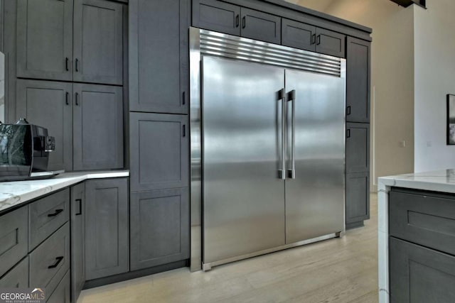 415 Green Ridge Trl, Blue Ridge, GA 30513 - kitchen featuring stainless steel built in fridge, light hardwood / wood-style floors, light stone counters, and gray cabinetry