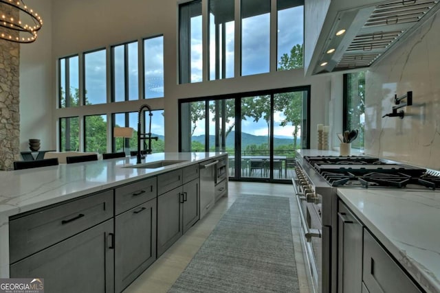 415 Green Ridge Trl, Blue Ridge, GA 30513 - kitchen featuring gray cabinetry, light stone countertops, high end stainless steel range, sink, and custom exhaust hood