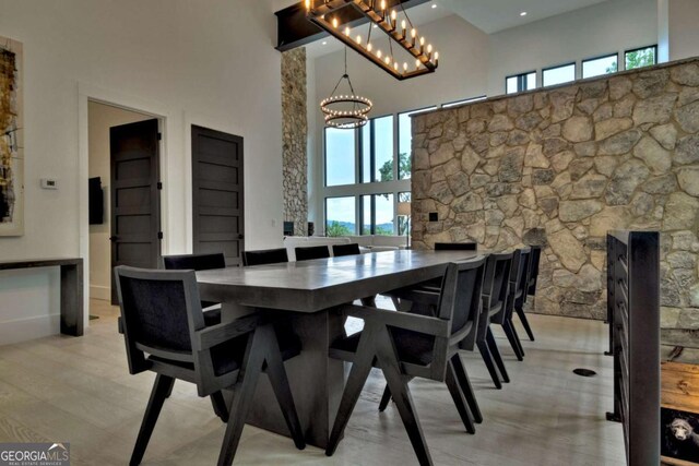 415 Green Ridge Trl, Blue Ridge, GA 30513 - dining space featuring a high ceiling, an inviting chandelier, and light hardwood / wood-style floors