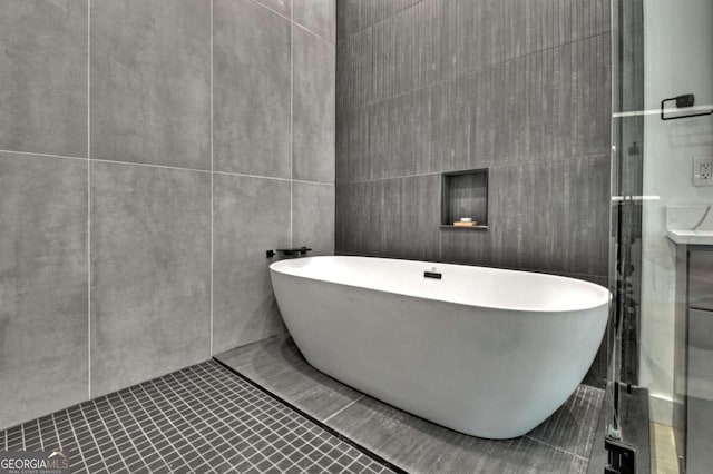 415 Green Ridge Trl, Blue Ridge, GA 30513 - bathroom with a tub to relax in, tile walls, and tile patterned flooring
