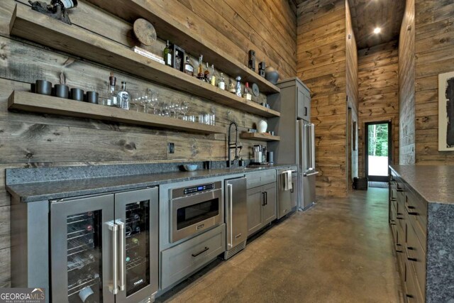 415 Green Ridge Trl, Blue Ridge, GA 30513 - bar featuring high quality fridge, gray cabinetry, beverage cooler, and wooden walls