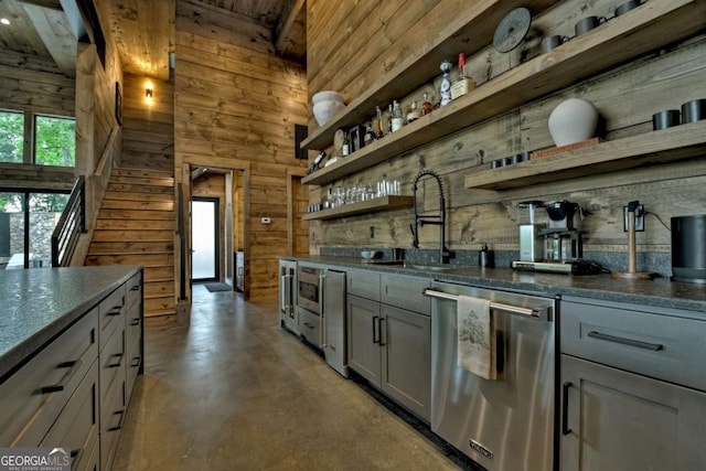 415 Green Ridge Trl, Blue Ridge, GA 30513 - bar with dark stone countertops, sink, wood walls, stainless steel appliances, and gray cabinets