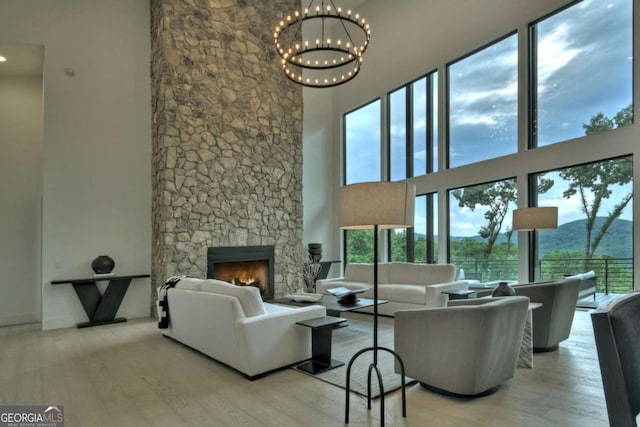 415 Green Ridge Trl, Blue Ridge, GA 30513 - living room featuring a fireplace, light hardwood / wood-style floors, and a high ceiling