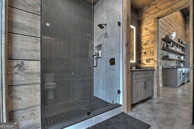 415 Green Ridge Trl, Blue Ridge, GA 30513 - bathroom featuring toilet, wooden walls, walk in shower, concrete floors, and vanity