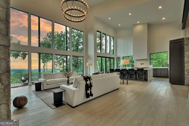 415 Green Ridge Trl, Blue Ridge, GA 30513 - living room featuring plenty of natural light, light hardwood / wood-style floors, and a high ceiling