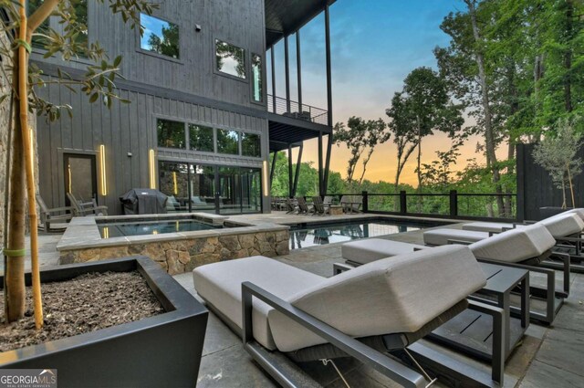 415 Green Ridge Trl, Blue Ridge, GA 30513 - patio terrace at dusk featuring a swimming pool with hot tub, a balcony, and grilling area