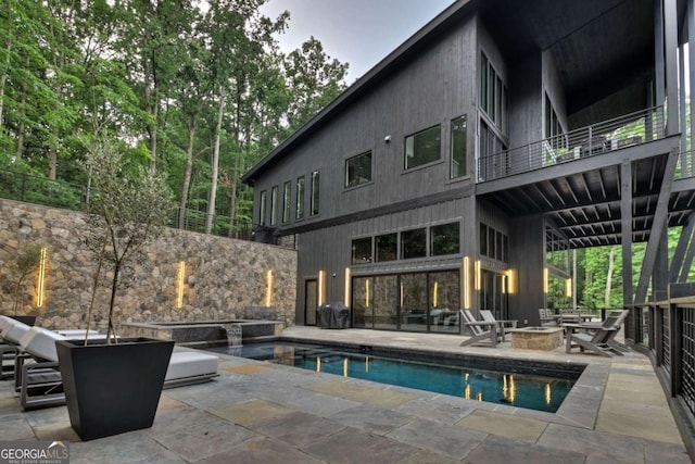 415 Green Ridge Trl, Blue Ridge, GA 30513 - back of property featuring a patio area, a fire pit, and a balcony
