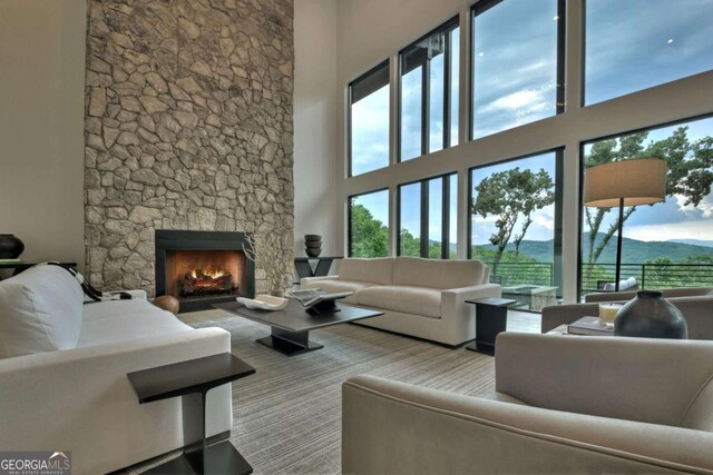 415 Green Ridge Trl, Blue Ridge, GA 30513 - living room featuring a mountain view, a towering ceiling, and a stone fireplace