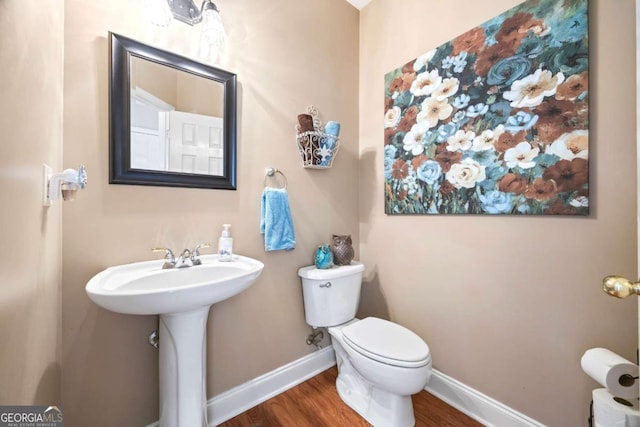 bathroom featuring sink, toilet, and hardwood / wood-style floors