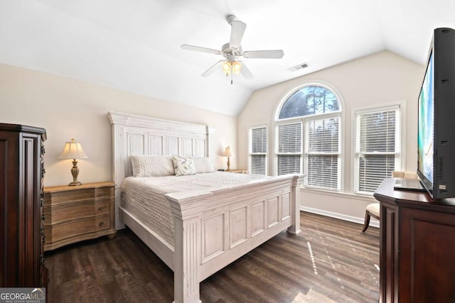 bedroom with ceiling fan, lofted ceiling, and dark wood-type flooring