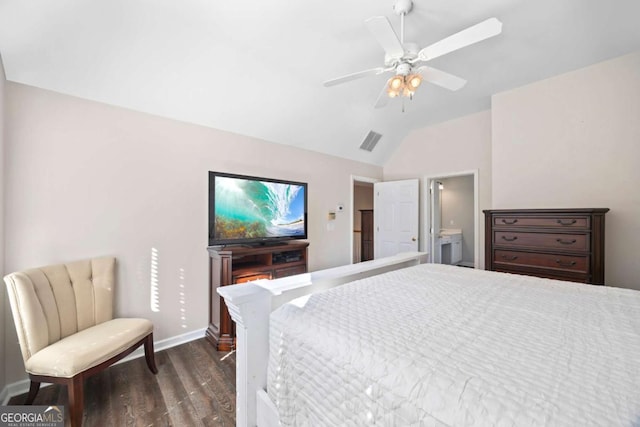 bedroom featuring dark wood-type flooring, lofted ceiling, ensuite bathroom, and ceiling fan