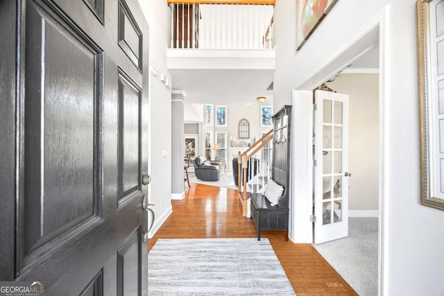 foyer entrance featuring a high ceiling and hardwood / wood-style flooring