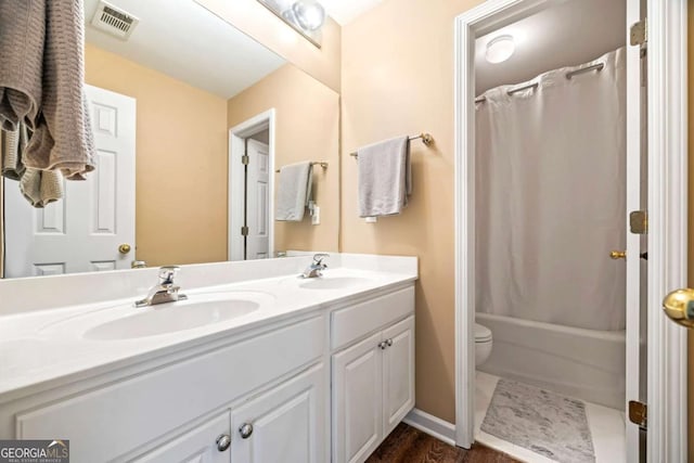 full bathroom featuring shower / bath combination with curtain, vanity, and toilet