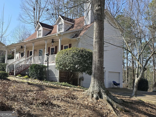 view of home's exterior with a garage and a porch