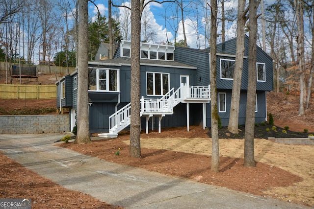 view of front of home featuring a trampoline, a deck, and stairs