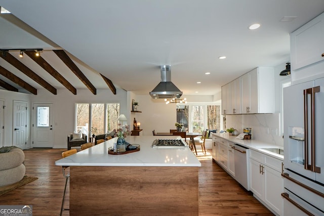 kitchen featuring stainless steel appliances, a center island, open floor plan, and white cabinets