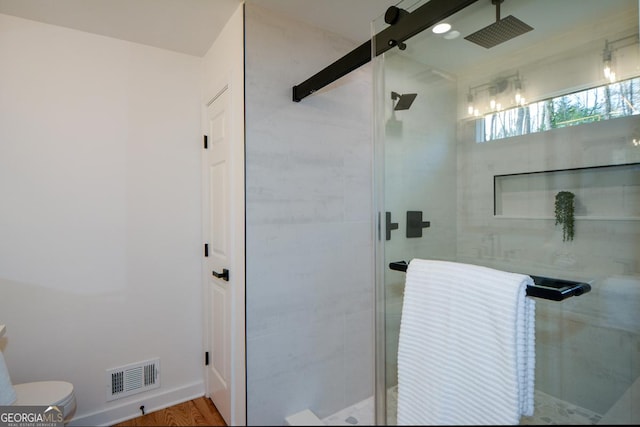 bathroom featuring visible vents, a shower stall, and toilet