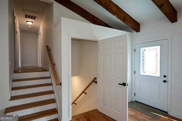 interior space featuring visible vents, beamed ceiling, and wood finished floors