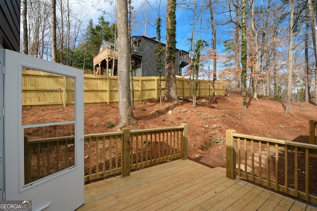 wooden terrace featuring fence