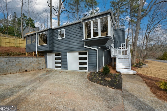 view of front of home featuring a garage, driveway, and a chimney