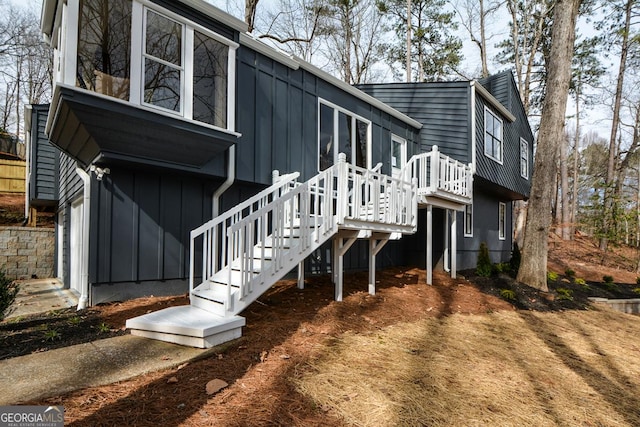 exterior space featuring stairway and board and batten siding