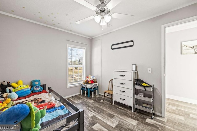 bedroom featuring hardwood / wood-style flooring, crown molding, and ceiling fan