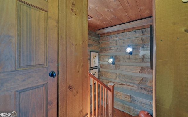 interior space featuring wooden ceiling and wood walls