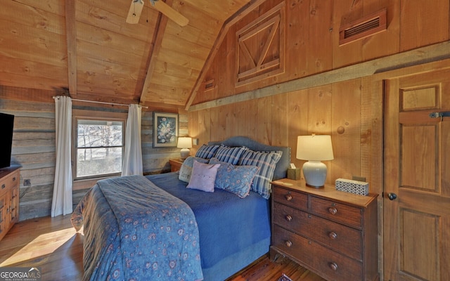 bedroom with vaulted ceiling with beams, dark hardwood / wood-style floors, wood walls, and wooden ceiling