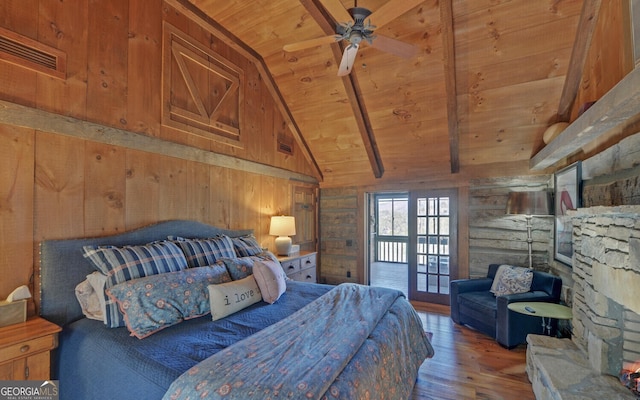 bedroom featuring hardwood / wood-style flooring, access to outside, wood ceiling, wood walls, and vaulted ceiling with beams